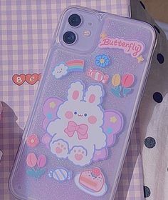 a phone case with an image of a teddy bear on it and some other items