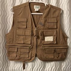 a brown vest hanging on a wall