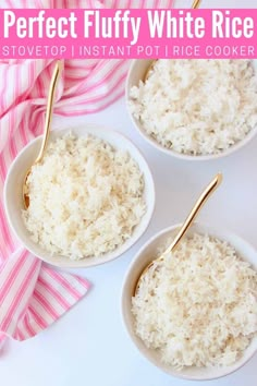 three white bowls filled with rice on top of a pink and white table cloth next to two gold spoons