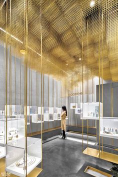 a room filled with lots of white and gold items in glass cases next to each other