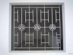 an image of a window that is on the side of a building with bars and circles in it