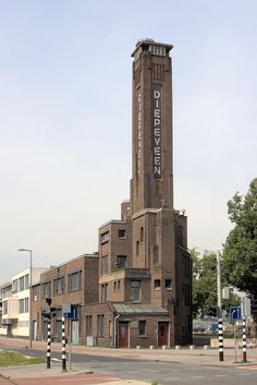 a tall brick building with a clock on the side of it's steeple