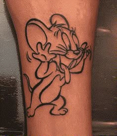 a cartoon mouse tattoo on the leg