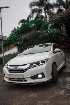 a white car parked in front of a house