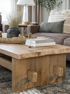 a living room with a couch, coffee table and books on top of the tables