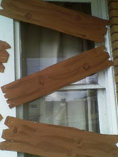 some wood planks are sticking out of the window