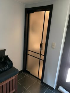 a room with a door that is open and has a bag on the floor next to it