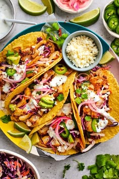 two fish tacos with cole slaw, avocado and cilantro