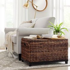 a living room with wicker furniture and a clock mounted on the wall above it