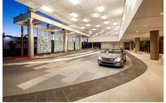 a car parked in front of a building with lights on it's ceiling and windows