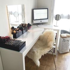 a desk with a computer on top of it