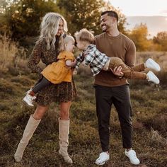 a man, woman and two children standing in a field