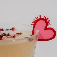 a drink in a glass with a red heart on the top