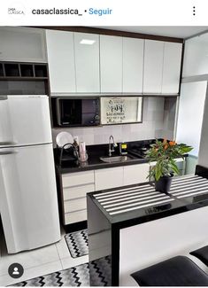 a kitchen with black and white checkered flooring, refrigerator and stove top oven