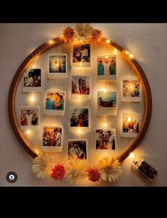 a circle with pictures and lights hanging from it's sides, surrounded by flowers