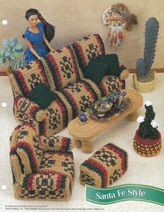 a crocheted couch and chair with a doll sitting on the end table in front of it