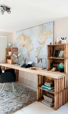 a wooden desk sitting in front of a map on top of a white floor next to a chair