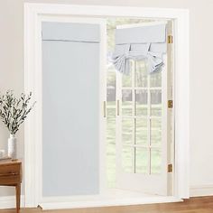 an open door with white curtains on it