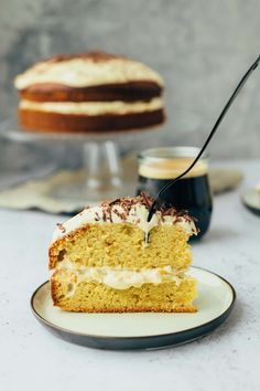 a piece of cake on a plate with a fork in it and another slice missing