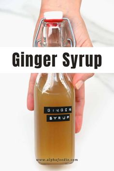 a hand holding a bottle of ginger syrup with the words ginger syrup on it in black and white