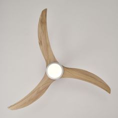 a wooden ceiling fan with a white light on it's blade and wood blades