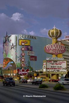 cars are driving down the street in front of hotels and casinos