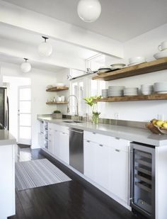 the kitchen is clean and ready to be used for cooking or baking, with white cabinets and stainless steel appliances