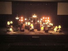 a group of people that are standing on a stage with some lights in front of them