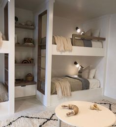 a room with bunk beds and white rugs