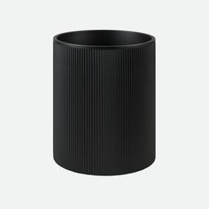 a black vase sitting on top of a white table