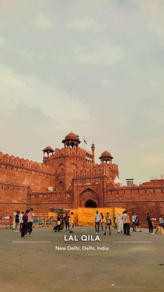 people standing in front of a large brick building