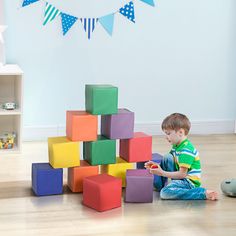 a young boy playing with blocks on the floor