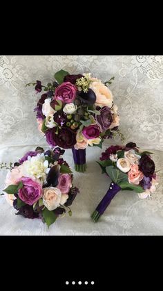 the bridal bouquets are laid out on the lace tablecloth, with purple and white flowers