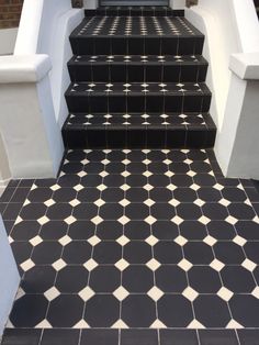 black and white tiled steps leading up to a door