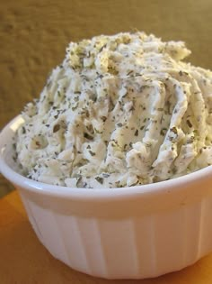 a white bowl filled with mashed potatoes on top of a table