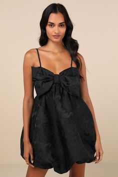 Get ready to be the sweetest babe around in the Lulus Coquettish Charm Black Bubble-Hem Bow Mini Dress With Pockets! Lightweight woven jacquard, in a chic floral motif, shapes adjustable spaghetti straps that support a babydoll-style dress with an adorable oversized bow at the front, creating a sweetheart neckline. Skirt has a super cute, puffy effect (with hidden side seam pockets) and finishes at an elasticized, bubble-style mini hem. Smocked panel at back for fit. Fit: This garment fits true White Bubble Dress, Mini Dress With Bow, Babydoll Style Dress, Bow Mini Dress, Semi Dresses, Bubble Style, Babydoll Mini Dress, Bubble Hem, Bubble Dress