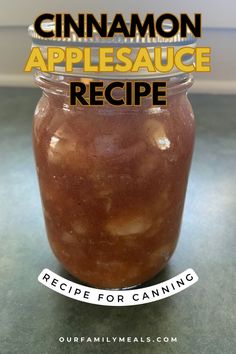 a jar filled with cinnamon applesauce sitting on top of a table