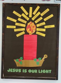 a bulletin board with the words jesus is our light and a lit candle on it