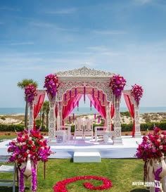 an outdoor wedding setup with pink and white flowers