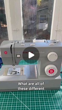 a sewing machine sitting on top of a green mat next to a window with the words, what are all of these different types of sewing machines?