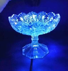 a blue glass bowl sitting on top of a table