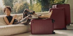 a woman is sitting on a bean bag chair with her feet propped up in the air