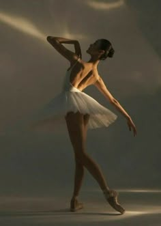 a ballerina in white tutu and ballet shoes