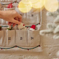 Celebrate the whole month of December with our festive one-of-a-kind advent calendar! Made in a lovely natural linen/cotton blend, it is inspired by some of our favorite Christmas motifs, the intricate details of holly, stars, lights, and berries will keep you merry for years to come! With an incredible attention to detail, this piece is an heirloom to last a lifetime! Hand-embroidered, made from 55% cotton/45% linen blend. Mini ornaments NOT included. Crafted with love by our artisans in India. Advent Calendar Pattern, Felt Advent Calendar, Christmas Motifs, Month Of December, Wrapping Gift Cards, Christmas Linen, Mini Ornaments, Small Sewing Projects, Christmas Advent Calendar