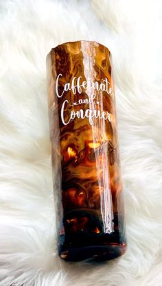 there is a glass bottle that says coffee and confection on the side, sitting on a white fur surface