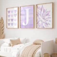 a white bed sitting next to two pictures on the wall