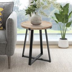 a living room scene with focus on the end table and chair next to the window