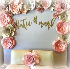 there is a cake decorated with flowers and the name kate & mark on it's side