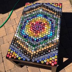 a table made out of bottle caps on the ground