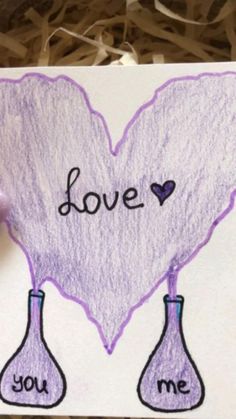 a piece of paper that says love with two test tubes in the shape of a heart